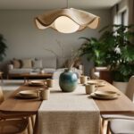 Warm modern dining room featuring a curved-edge dining table, textured textiles, sculptural pendant lighting, and earthy décor accents.